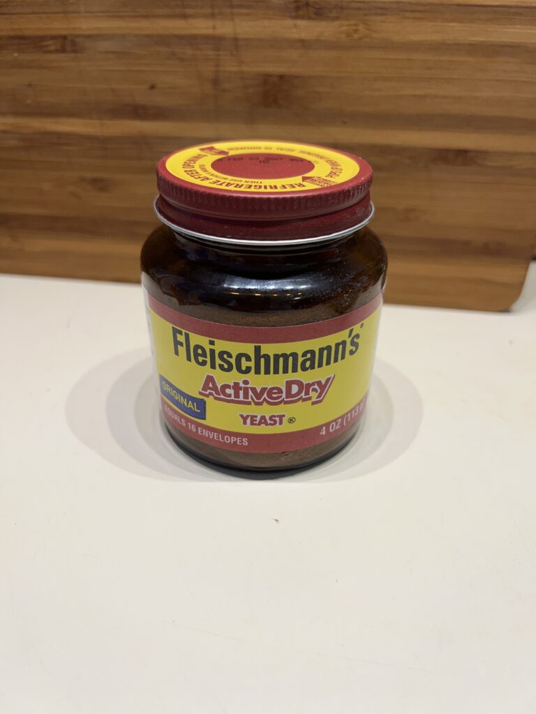 A jar of Fleischmann's Active Dry Yeast, waiting patiently to be woken up and given yummy sugar in exchange for becoming bread.